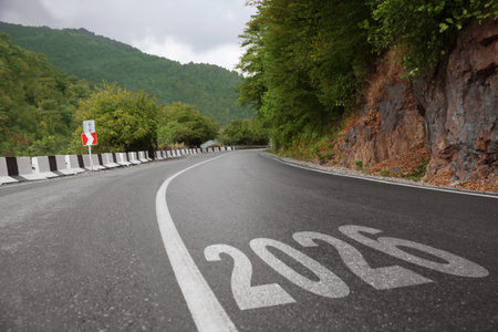 Numbers written on asphalt road in mountains