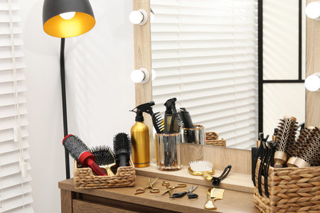 Different hair styling tools on wooden vanity in salonの写真素材