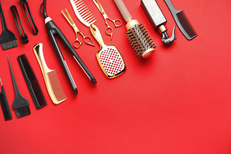Different hair styling tools on red background, flat lay. Space for textの写真素材