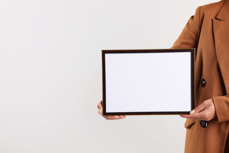 Woman with diploma blank frame on light background, closeup. Mockup for designの写真素材