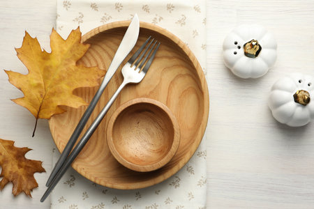 Beautiful table setting with autumn decor on white wooden background, flat layの写真素材