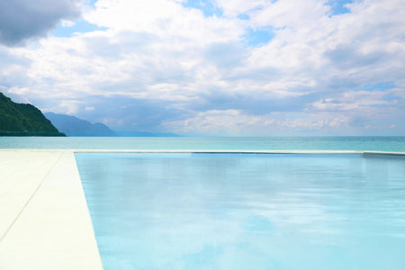Swimming pool with clear water and infinity view on oceanの写真素材