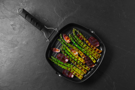 Delicious grilled vegetables in pan on dark textured table, top viewの写真素材