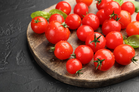 Fresh ripe tomatoes and basil on gray textured table, closeupの写真素材