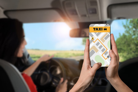 Man sitting in taxi that he called via mobile phone app, closeup