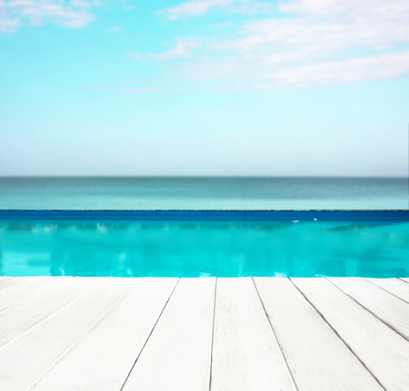 Swimming pool with clear water and infinity view on oceanの写真素材