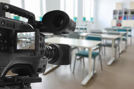 Video camera in empty classroomの写真素材