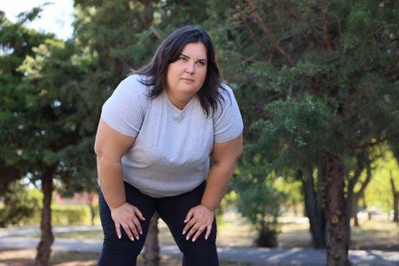 Tired woman after running in park. Space for textの写真素材