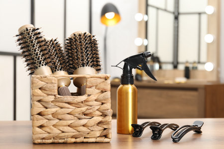 Different hair styling tools on wooden table in salon, closeupの写真素材