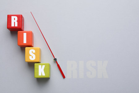 Risk word made of wooden cubes and arrow on gray background, top viewの写真素材