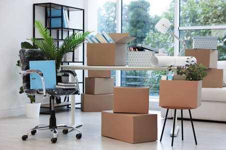 Moving boxes and furniture in new officeの写真素材