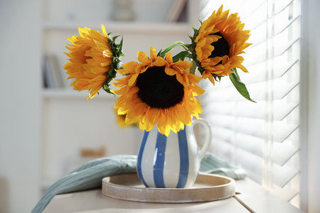 Beautiful sunflowers in vase near window indoors, closeupの写真素材