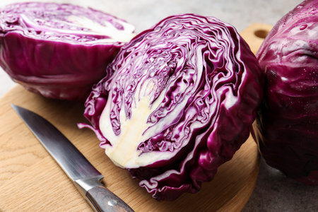 Fresh red cabbages and knife on gray table, closeupの写真素材