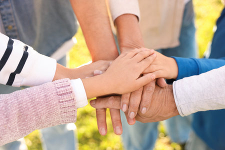 Parents and their children holding hands outdoors, closeup. Family bondingの写真素材