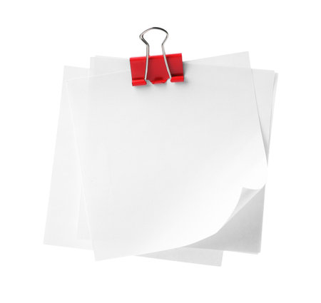 Blank paper notes attached with blinder clip isolated on whiteの写真素材