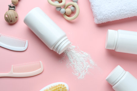 Bottle of talcum powder and baby accessories on pink background, flat layの写真素材