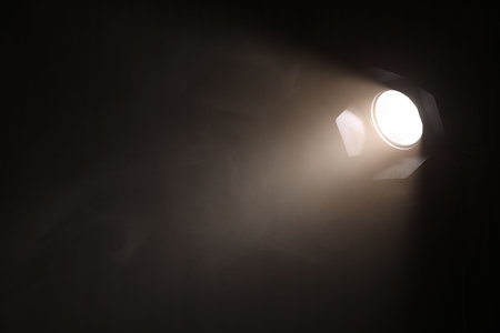 Professional lighting equipment without reflector and smoke on dark background. Space for text