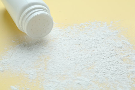 Bottle of talcum powder on yellow background, closeupの写真素材