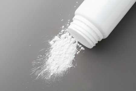 Talcum powder and plastic bottle on gray background, top viewの写真素材