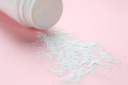 Bottle of talcum powder on pink background, closeupの写真素材