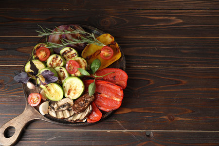 Vegetarian barbeque. Tasty grilled vegetables served on wooden table, top view. Space for textの写真素材