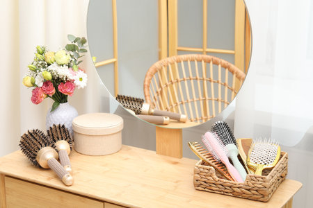 Different hair styling tools on wooden vanity indoorsの写真素材