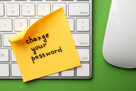 Note with phrase Change your password, mouse and keyboard on green background, top viewの写真素材