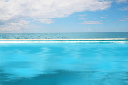 Swimming pool with clear water and infinity view on oceanの写真素材