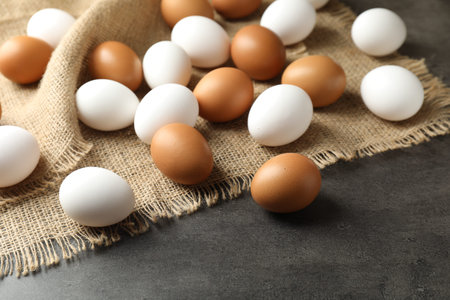 Many raw eggs on gray table