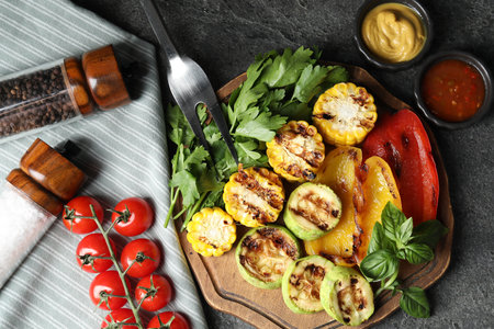 Vegetarian barbeque. Tasty grilled vegetables served on gray table, flat layの写真素材