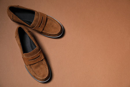 Pair of stylish brown shoes on color background, flat layの写真素材