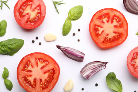 Ripe red tomatoes, spices and herbs on white background, flat layの写真素材
