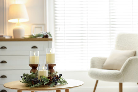 Beautiful LED candles and festive decor on wooden table indoors. Space for textの写真素材