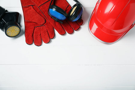 Different safety equipment on white wooden table, flat lay. Space for textの写真素材