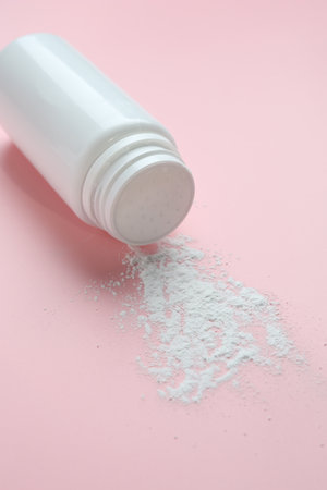 Bottle of talcum powder on pink background, closeupの写真素材