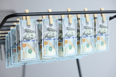Money laundering. Banknotes hanging on drying rack indoors, closeupの写真素材