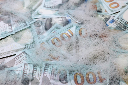 Money laundering. Many dollar banknotes and foam as background, closeupの写真素材