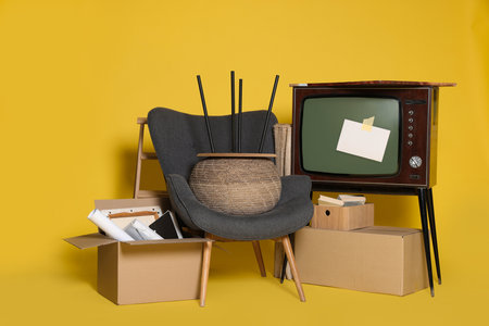 Garage sale. Different used stuff on yellow backgroundの写真素材