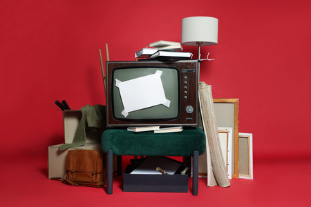 Garage sale. Different used stuff with blank card on red backgroundの写真素材