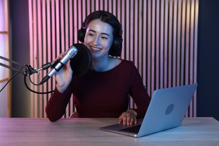 Podcast host recording talk show in studioの写真素材