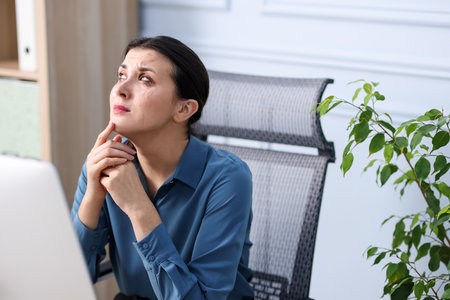 Young businesswoman on chair in officeの写真素材