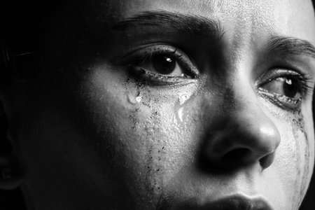 Closeup view of sad young woman crying. Black and white effectの写真素材