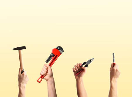 People holding different tools in hands against beige gradient background, closeup. Collageの写真素材