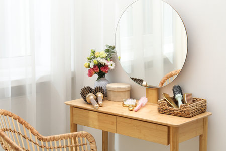 Hair styling. Different combs and brushes on wooden vanity indoorsの写真素材