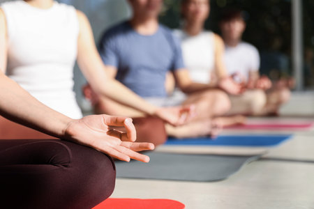 Group of teenagers practicing yoga on mats indoors, closeup. Space for textの写真素材