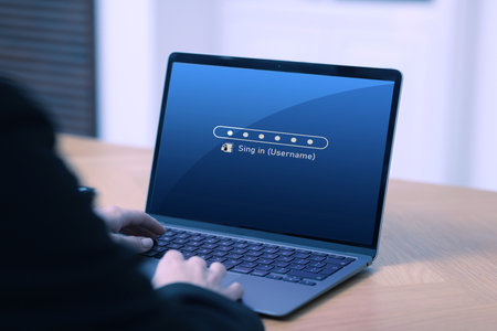 Woman entering password to sign in to user account on laptop at table, closeupの写真素材