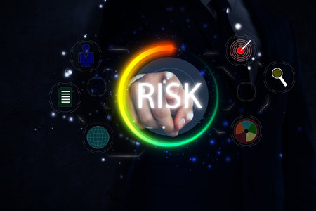 Businessman touching scheme with word Risk and different icons on virtual screen, closeupの写真素材