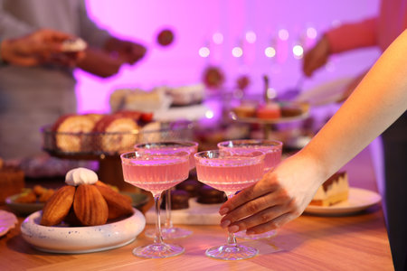 People with drinks and delicious desserts at buffet table, selective focusの写真素材
