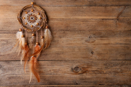 Beautiful dream catcher on wooden background, top view. Space for textの写真素材