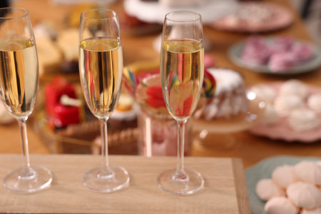 Buffet menu. Glasses of sparkling wine and desserts on table, selective focusの写真素材